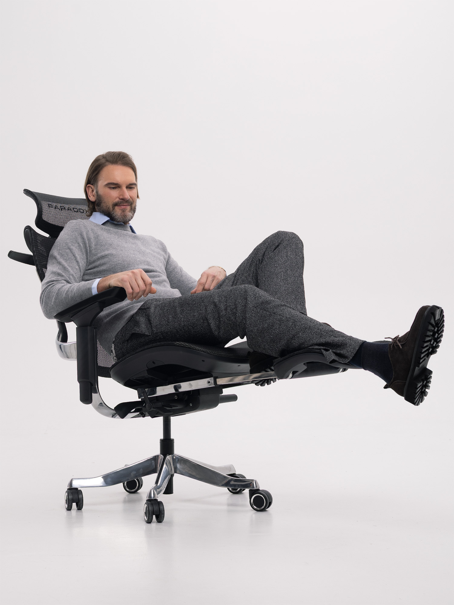 Man working at standing desk with Paradox Ergo Milano Pro Black chair